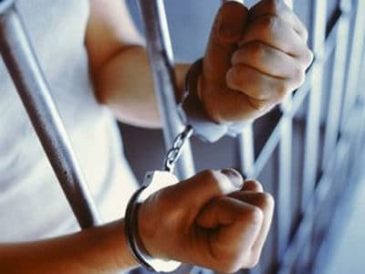 hands behind bars in cuffs